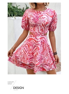 Detail of pink marble print dress showing puff sleeves and layered ruffle hemline