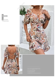 Detail of floral print mini dress featuring waist cut-outs and criss-cross back tie design