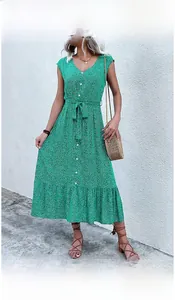 Detail of green floral summer midi dress with white buttons and ruffled hemline