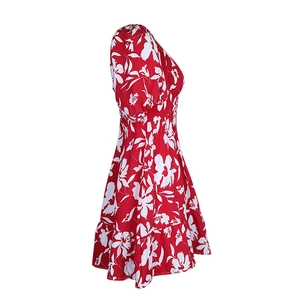 Detail of red floral dress featuring puff sleeves and ruffled hem with a side view
