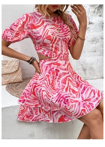 Detail of pink marble print dress featuring waist cut-out and layered ruffle skirt design