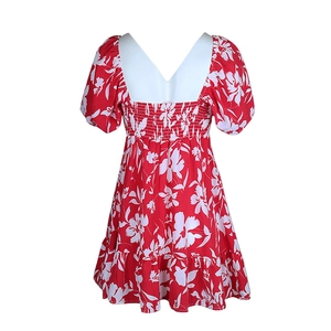 Detail view of the smocked back design on a red and white floral French dress