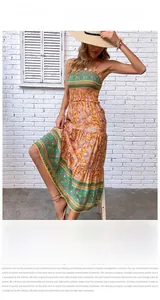 Detail of bohemian orange sundress featuring ethnic floral print and smocked bodice design