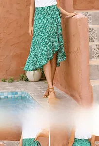 Detail of green polka dot wrap skirt featuring ruffled hem and asymmetric design