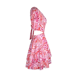 Detail of summer dress featuring cutout waist, marble print, and layered ruffle skirt