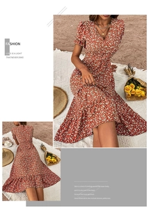 Detail of V-neck puff sleeves and ruffled hem on vintage orange floral summer dress