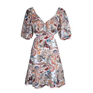 Detail of V-neck floral print dress featuring puffed sleeves and stylish waist cut-outs