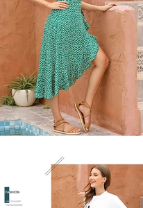 Detail of green polka dot wrap skirt with ruffle hem and lace-up flat sandals