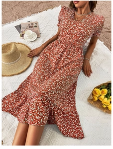 Close-up of red floral V-neck dress with ruffle hem detail and summer holiday vibes
