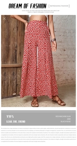 Detail showing the red high-waisted wide-leg pants with delicate white floral pattern
