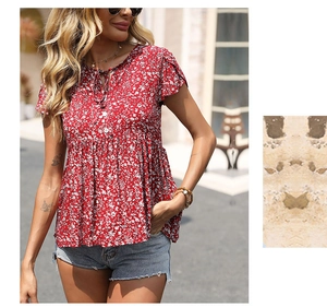 Detail of red floral blouse featuring a V-neckline with ties and lightweight fabric