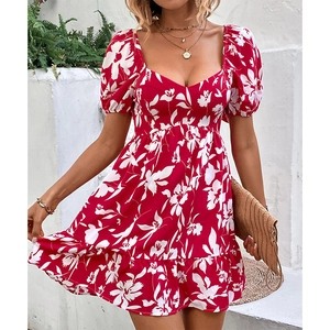 Floral red tea dress with puff sleeves and heart neckline on a summer outdoor model