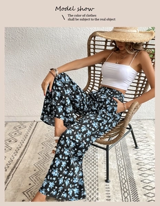 Close-up of high-waist floral wide-leg trousers with blue print for summer vacation