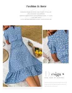 Detailed close-up showing the blue floral print fabric and ruffled hem of the summer dress