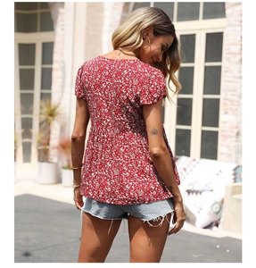 Outdoor back view of a red floral babydoll top with short sleeves and summer denim shorts