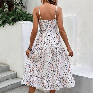 White midi dress with colorful butterfly prints and ruffled hem in elegant summer style
