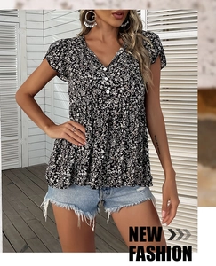 Detail of V-neck floral print top with white buttons and ruffled short sleeves