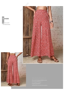Detail of red floral wide leg trousers with high waist and bohemian chiffon pattern