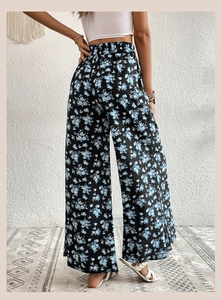 Macro view showing the drape and blue floral print texture on these wide leg pants