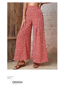 Detailed view of high waist floral wide leg trousers in red with star pattern