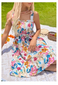 Detail of square neckline and floral print on summer dress in a picnic outdoor setting