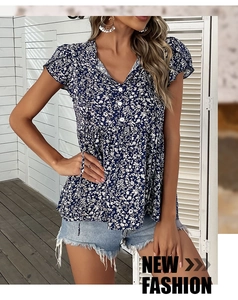 Detail of dark blue floral V-neck tunic blouse with decorative buttons and babydoll hem