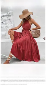 Detail of red halter neck tiered maxi dress with belted waist in a bohemian style