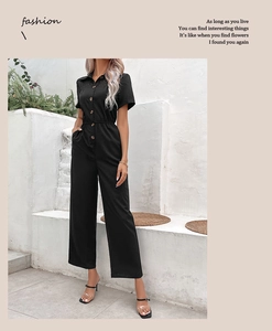 Detail of short sleeve black jumpsuit with lapel collar and elastic waist design