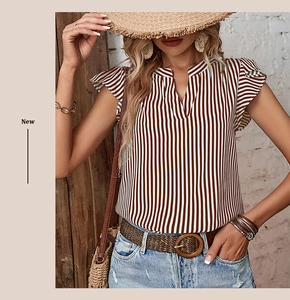 Detailed view of ruffled flutter sleeves and brown vertical stripes on the v-neck summer top