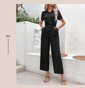 Detail of black short sleeve jumpsuit featuring button-front and hollow-out chest design