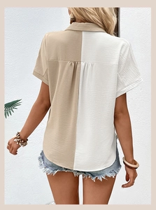 Detail view of the back of a women's short sleeve shirt with khaki and white color blocking