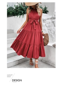 Detail of red halter neck dress featuring a tied waist and layered tiered A-line skirt