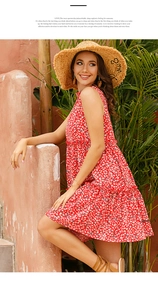 Detail of red floral sleeveless dress with white daisy pattern and ruffled hem for summer