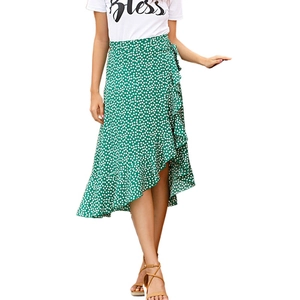 Green wrap skirt with white polka dots featuring irregular ruffle hem and waist tie