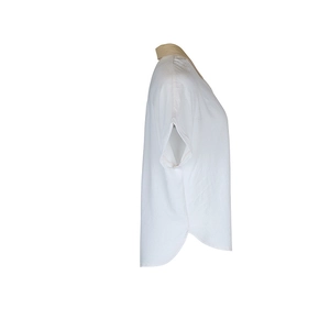 Detail view of contrast lapel collar and curved split hem on summer short sleeve shirt
