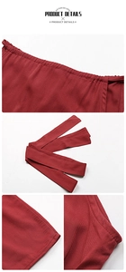 Detail view of burgundy A-line dress featuring twill fabric texture and matching tie belt