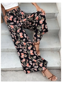 Detail of high waist floral wide leg pants with elastic drawstring and tropical print