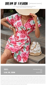 Detail of red and white floral print wrap dress with a woven bucket bag and straw hat