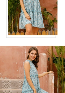 Detail shot of light blue floral dress showing delicate daisy pattern and ruffle hemline