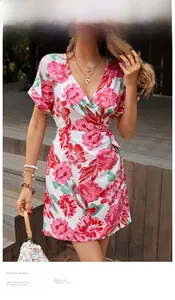 Detail of V-neck wrap dress featuring a vibrant floral print and a matching waist tie