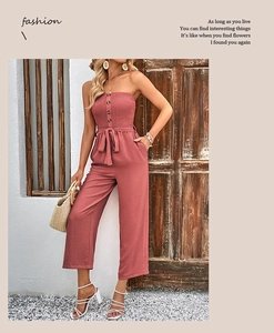 Detail of strapless wide-leg jumpsuit with decorative buttons and waist tie in dusty pink