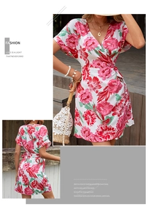 Detail of floral wrap dress featuring V-neckline and vibrant pink flower patterns