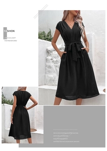 Detail of a black V-neck dress featuring a waist tie and practical side pockets