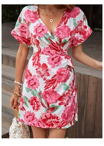 Detail of floral wrap summer dress featuring deep V-neck and vibrant pink floral patterns