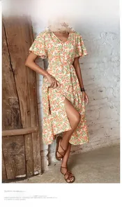 Detail of floral midi dress featuring V-neck buttons and side slit in retro style