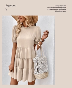 Detailed view of layered beige summer dress with tiered ruffles and pleated puff sleeves