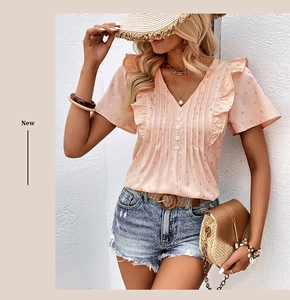 Detail of pink chiffon top with V-neck ruffles and golden diamond patterns