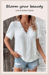 Detailed view of white Swiss dot lace V-neck blouse with ruffled sleeves and intricate trim