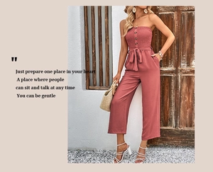 Detail of strapless mauve jumpsuit with smocked bodice, buttons and waist belt