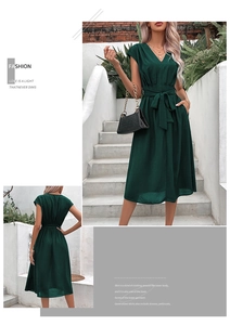 Detail of a dark green V-neck sleeveless summer dress with waist belt and flowy midi skirt